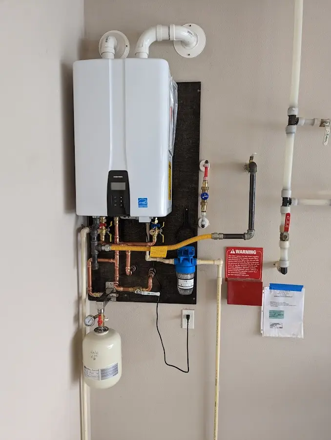 Professional plumber installing copper piping in a Warrior home